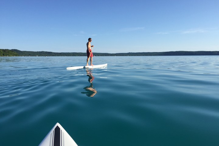 a person riding a surf board on a body of water