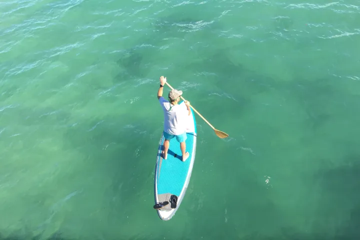 a person riding a surf board on a body of water