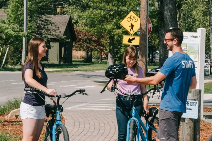 a group of people riding on the back of a bicycle
