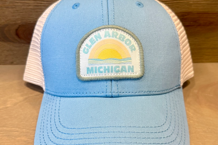 Blue baseball cap with 'Glen Arbor Michigan' patch featuring a sun and waves.