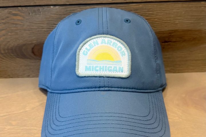 Blue cap with 'Glen Arbor Michigan' patch featuring a sun and waves.