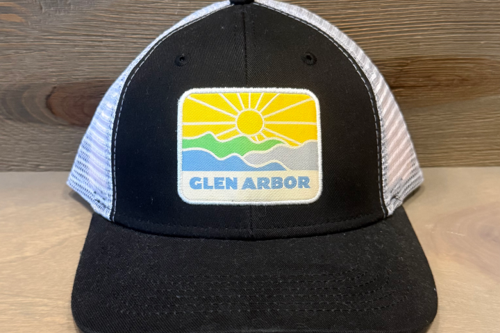 Black mesh cap with Glen Arbor patch, featuring sun and waves design.