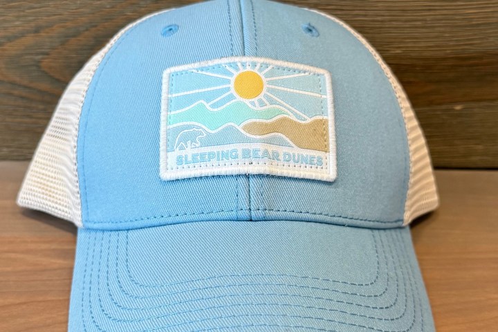 Light blue and white cap with 'Sleeping Bear Dunes' and sun design on the front patch.