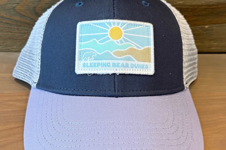 Trucker hat with 'Sleeping Bear Dunes' patch showing sun and dunes design.