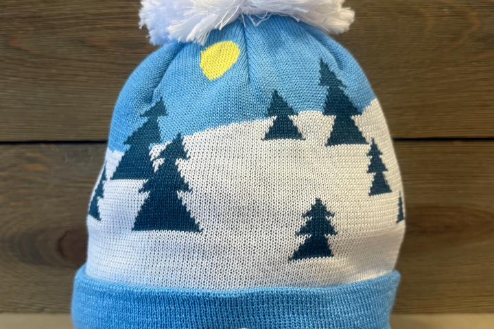 Blue and white beanie with trees, sun, and 'Take a Hike' patch.